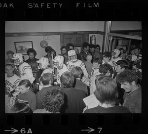 Members of the Boston State College lacrosse team pass by Black students standing guard at door of administration building where they are demonstrating