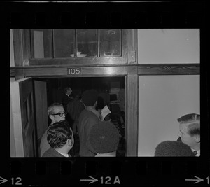 Partial view of people entering Room 105 at Boston State College during the Black student protest
