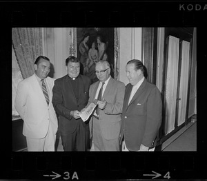 Four men, including a clergyman, holding a July 1970 issue of the Pats Patter newsletter
