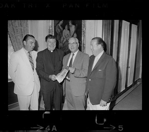 Four men, including a clergyman, holding a July 1970 issue of the Pats Patter newsletter
