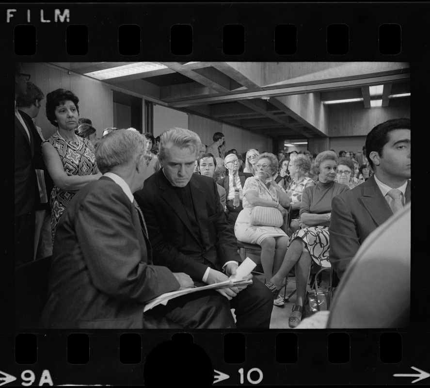 Rev. W. Seavey Joyce, president of Boston College, in conversation with Atty. Lewis H. Weinstein at hearing