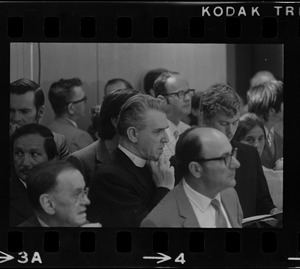 Rev. W. Seavey Joyce, president of Boston College, seen in middle of a crowd at the City Hall hearing