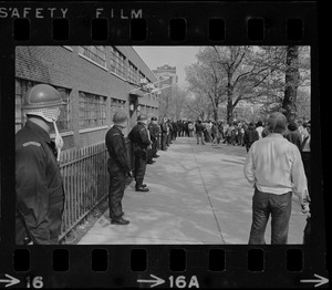 Policemen line up in front of the administration building at the National Guard Armory during student protests