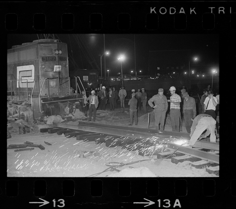 Emergency crew working on track of runaway Penn Central train on Southeast Expressway in South Boston