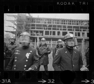 Police standing in front of Tufts University dormitory construction site, center of student opposition