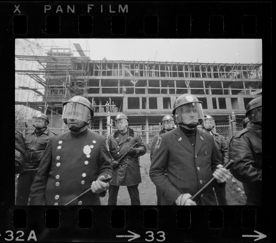 Police standing in front of Tufts University dormitory construction site, center of student opposition