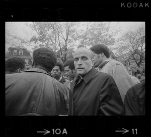 Rev. Robert Drinan, Dean of Boston College Law School and committee chairman of Massachusetts Advisory Committee to the US Civil Rights Commission, standing with a group of black protesters during Tufts University student opposition to dormitory construction