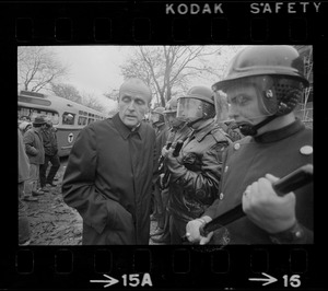 Rev. Robert Drinan standing in front of police guarding the Tufts University dormitory construction site that is at the center of student opposition