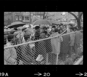 Protesters standing by a fence bordering the Tufts University dormitory construction site, center of student opposition