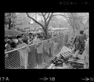 Protesters lined up along a fence bordering the Tufts University dormitory construction site that is at the center of student opposition