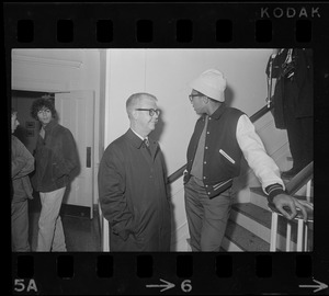 Tufts University President Burton Hallowell, left, speaking with a Black student by the stairwell during student protests