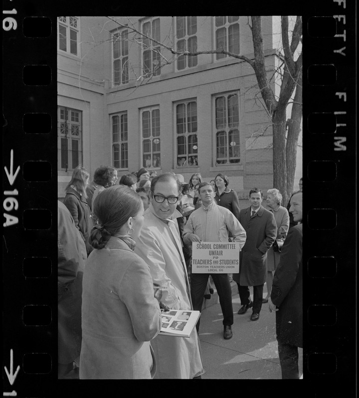 Students at Girls Latin High School sing folk songs about, and in support of, their teachers who yesterday walked picket lines along the perimeter of the school