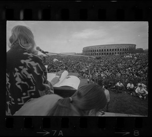 Thousands of student demonstrators sit peacefully on the grounds of Harvard's Soldiers Field as they listen to Margaret Marshall of South Africa, a graduate student of Harvard School of Education
