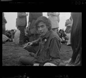 Student protestor lying in the grass during rally at Soldiers Field