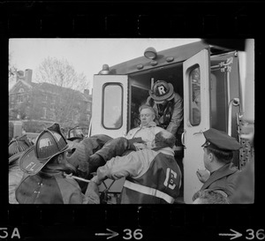 A man being carried by rescue workers into an ambulance