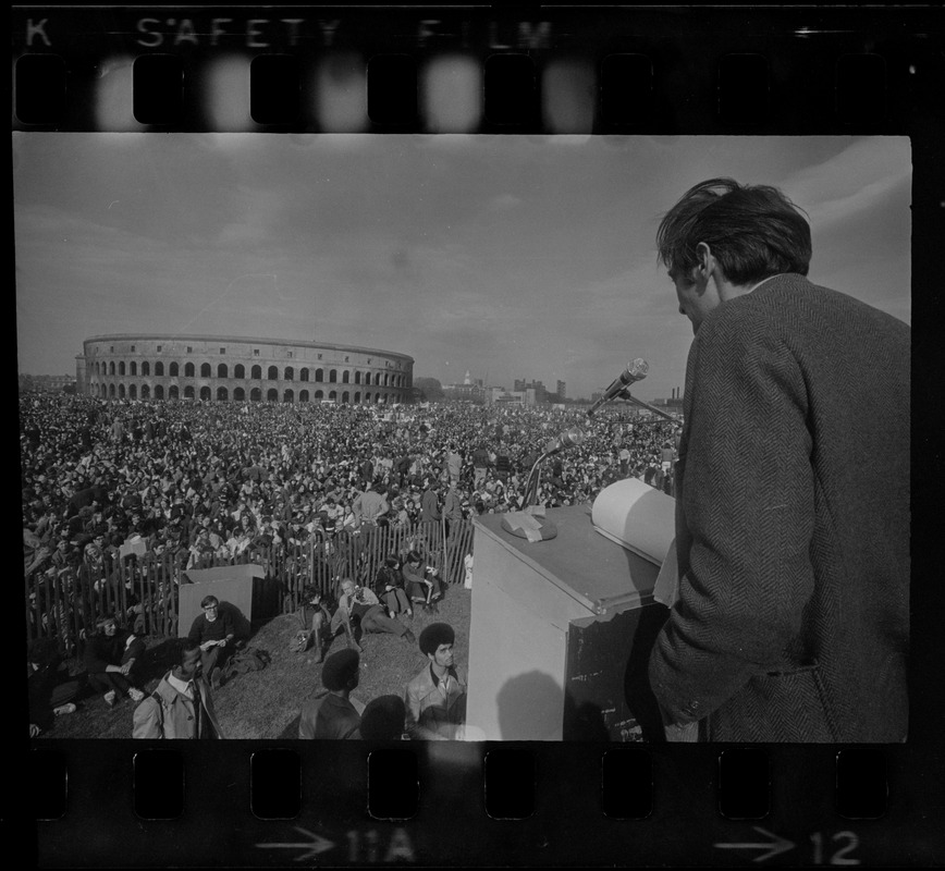 A man speaking to the crowd at a student rally at Soldiers Field