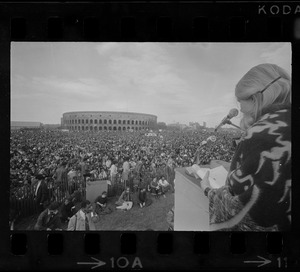 Thousands of student demonstrators sit peacefully on the grounds of Harvard's Soldiers Field as they listen to Margaret Marshall of South Africa, a graduate student of Harvard School of Education
