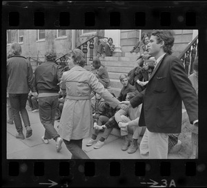 Student protesters seen on steps of and marching around University Hall in Harvard Yard