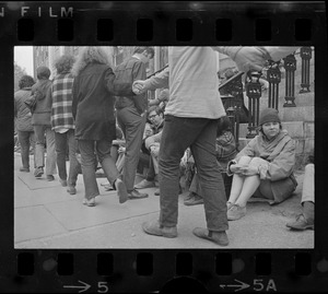 Student protesters seen on steps of and marching around University Hall in Harvard Yard