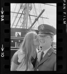 Second lieutenant receiving a kiss aboard the USS Constitution after the Tufts NROTC commissioning ceremony