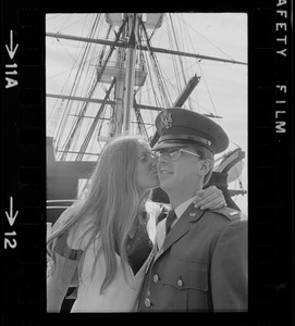 Second lieutenant receiving a kiss aboard the USS Constitution after the Tufts NROTC commissioning ceremony