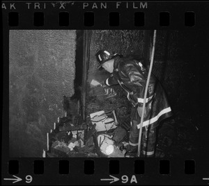 Firefighter views remains of firebombed office at Tufts University Fletcher School of Law and Diplomacy