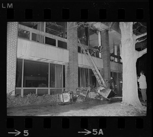 Firemen probe through debris following a three-alarm fire which destroyed offices of two Tufts University deans in the Fletcher School of Law and Diplomacy