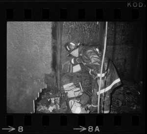 Firefighter looking through remains of firebombed office at Tufts University Fletcher School of Law and Diplomacy