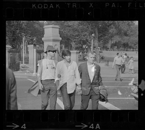 Three men crossing the street near the Boston Common