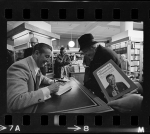 Lawrence Welk signing a copy of his autobiography, "Wunnerful, Wunnerful," for a fan at Jordan's Bookmart