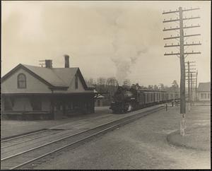 Train station, with a steam engine approaching from the north
