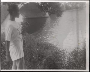 Girl standing near water's edge
