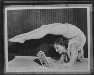 Los Angeles dancer Gertrude Fisher takes an unusual position to read the latest novel of her husband M.S. Meritt