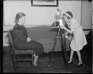 Alyce Jane McHenry turns news cameraman, while Dolores Crispo, her favorite Nurse, poses at the Nurses Home, Fall River
