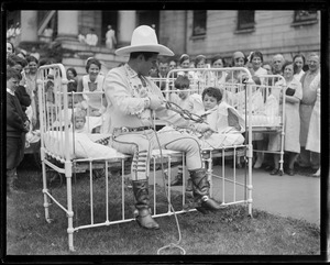 Tom Mix shows young boy how to tie a knot at Mass. General
