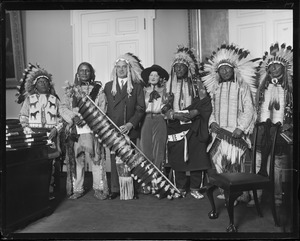Gov. Allen poses with Indians from the 101 Ranch at the State House. Gov. Allen is "Chief City Bear," Chief Spider of the Sioux is to the right and Dixie Starr on his left.