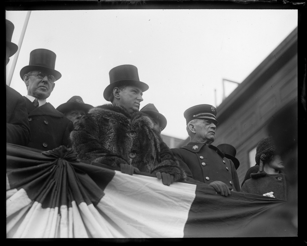 Mayor Curley in top hat and fur, with Fire Chief Tabor on reviewing stand