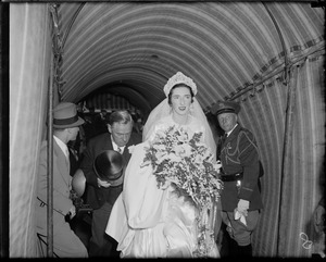 Mary Curley and his father James M. Curley on their way into her wedding reception