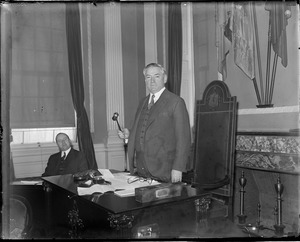 Gov. Curley at his desk with gavel in hand