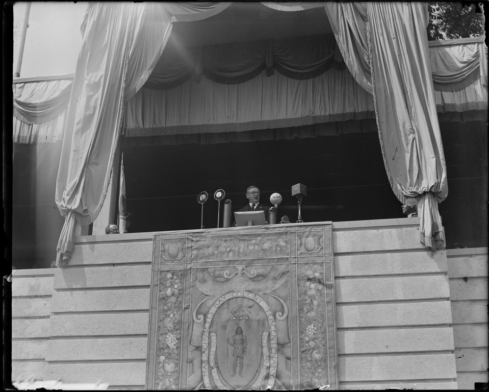 Mayor Curley speaking from dais in auditorium during the Tercentenary