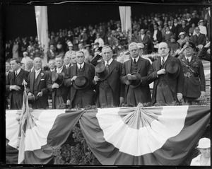 J.M. Curley and other dignitaries stand with doffed hats during anthem at ball game