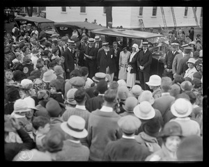 Pres. Coolidge and Mrs. Coolidge and party stand by their car while the famous carillons play at St. Stephen's church in Cohasset