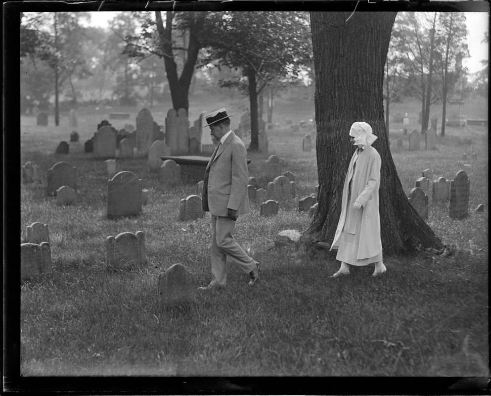 Pres. Coolidge and wife walking in cemetery