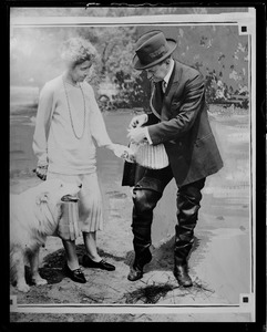 Mrs. Coolidge helps her husband gear up for fishing