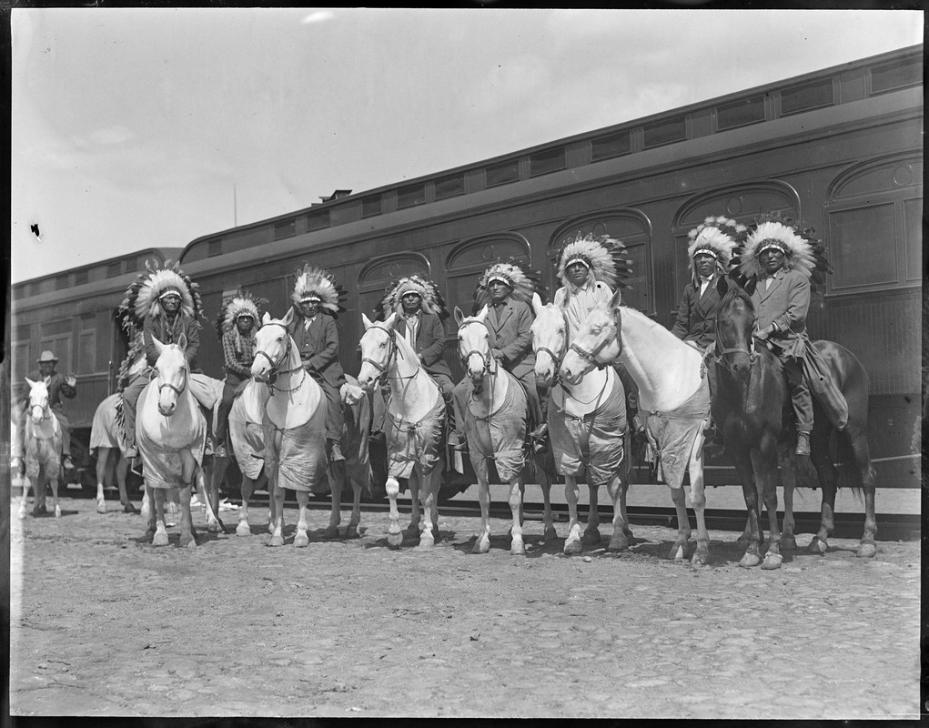 Indians on horses in front of train