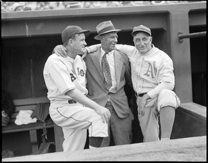 Player-Manager of the Red Sox in Fenway dugout with Athletic and man in suit.