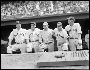 A's player poses with Red Sox players in dugout at Fenway (Lefty Grove to left; Jimmie Foxx second from right)