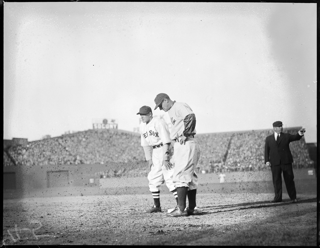 Joe Cronin of the Sox held on first by Lou Gehrig of the Yankees