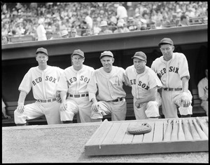 Athletics player poses in dugout with Red Sox players. (Far left Lefty Grove, Jimmie Foxx 2nd from right)