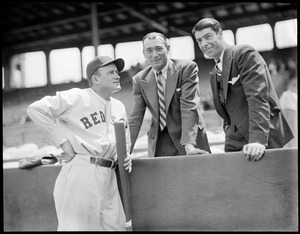 Red Sox players with two men. One is Joe DiMaggio out of uniform.